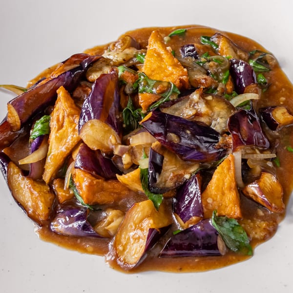 Stir-fried eggplant and tofu in a rich brown sauce with fresh basil and onions.