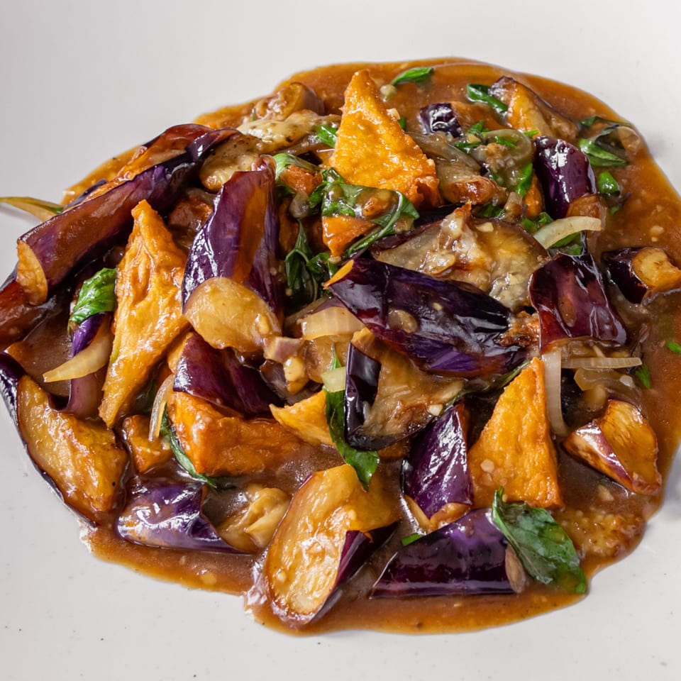 Stir-fried eggplant and tofu in a rich brown sauce with fresh basil and onions.